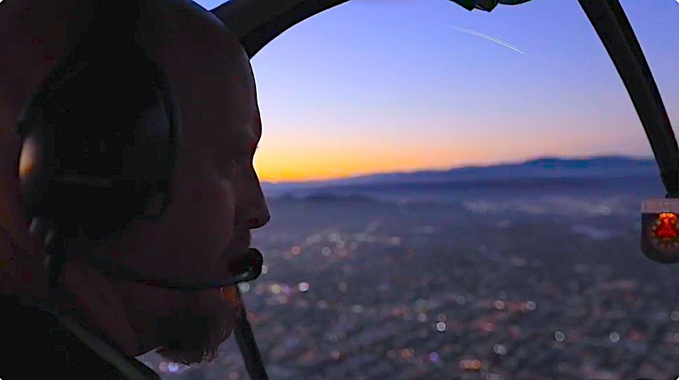 Greg Cash filming from helicopter at sunset